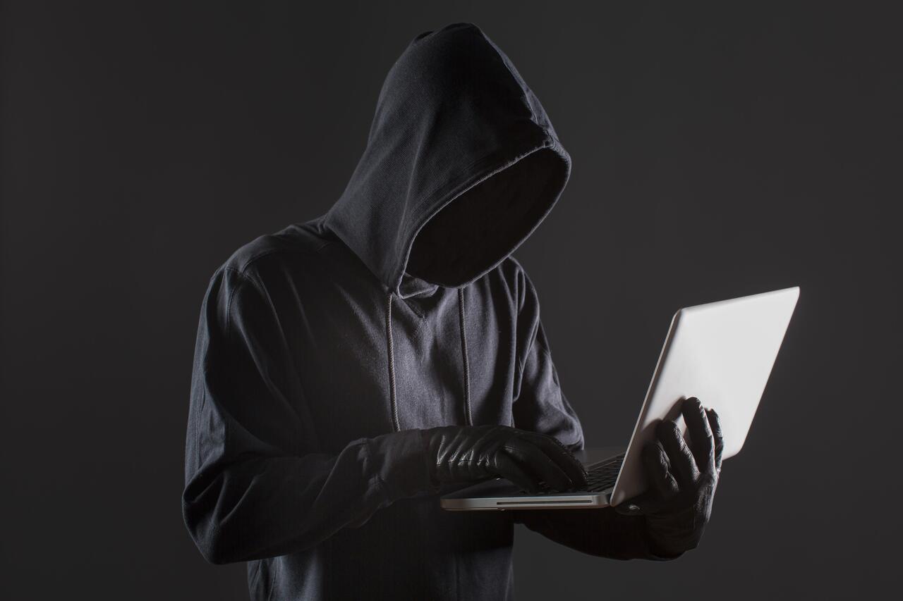 side-view-male-hacker-with-gloves-laptop_3_1.jpg
